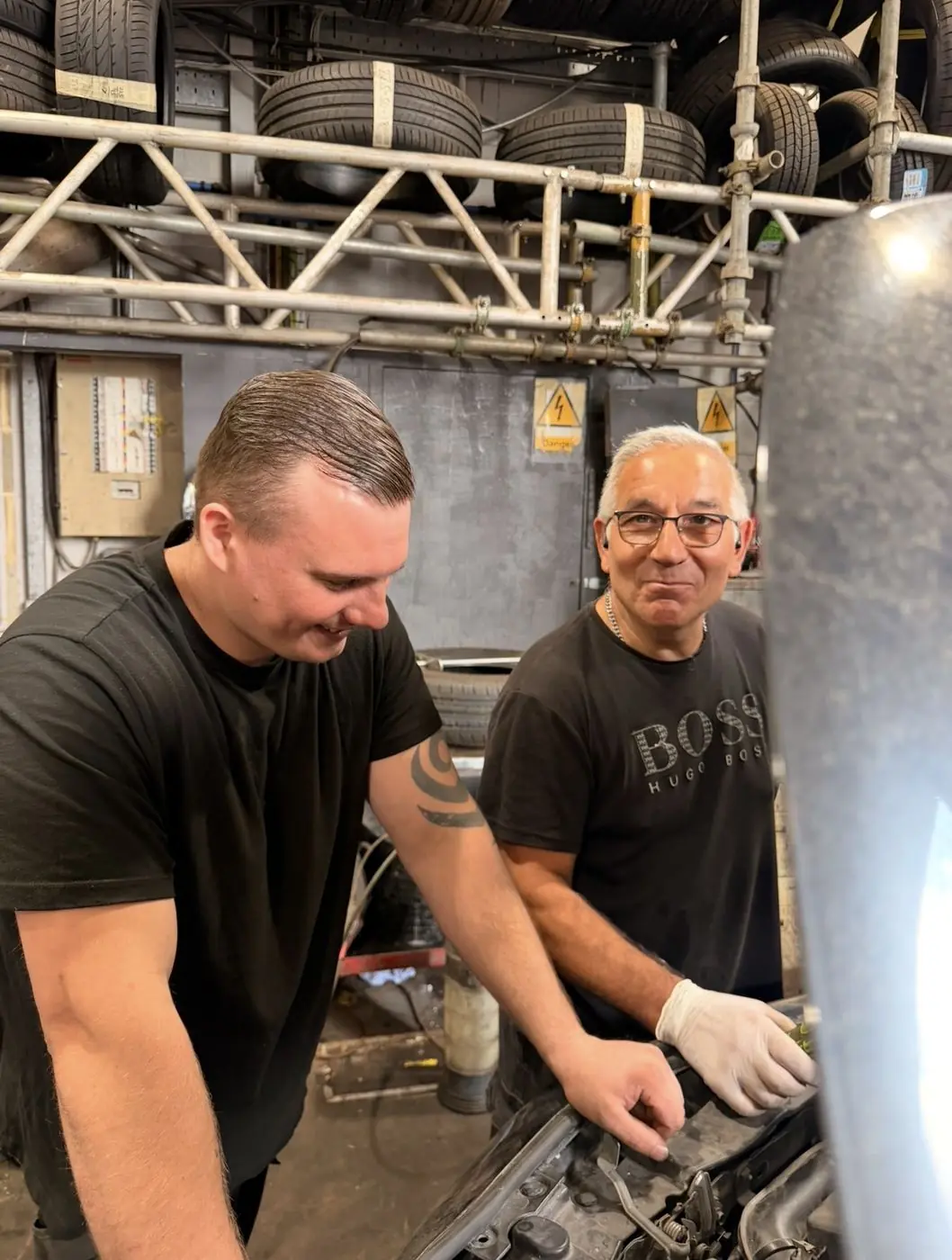 Two White Rose Motors mechanics working together